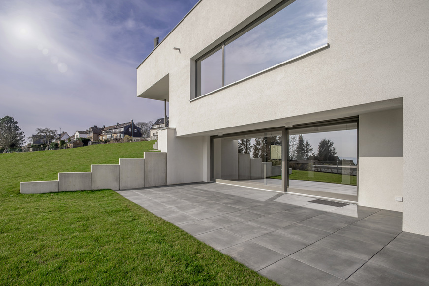 Großflächige Fenster und Schiebetüren prägen die optische Erscheinung und sorgen für weite Sicht und lichtdurchflutete Räume.