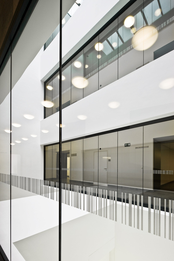 Um die Gefahr zu minimieren, dass Gebäudenutzer versehentlich in die Glaswände hineinlaufen, wurden die Glasflächen mit einem Barcode bedruckt.