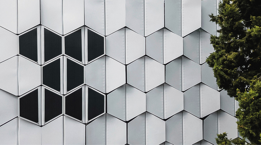 Die FlectoLine-Fassade mit geschlossenen Modulen. Auf einigen Elementen sind Photovoltaikelemente integriert.