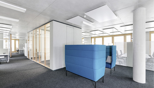 Die Büro-Kuben werden durch Kommunikations-Orte (hier blaue Sofas) ergänzt.