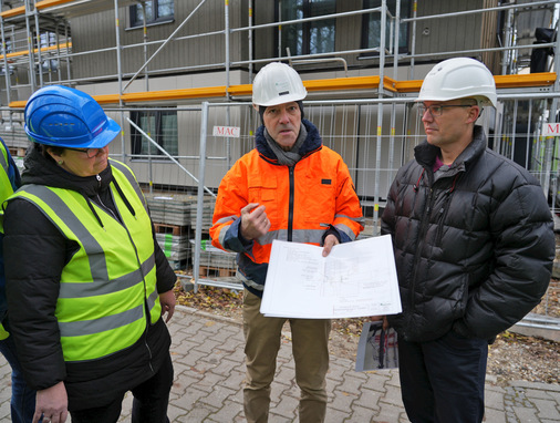 Josef Huber (GF Huber & Sohn) erklärt anhand von Konstruktionsdetails die Lösung der Brandschutzanforderung. (v.l.n.r. Anyke Aguirre Cano (ift), Josef Huber und Projektleiter Martin Nachtwey (Huber & Sohn))