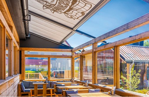 Die Pergola-Anlage, die normalerweise auf Säulen steht, wurde optisch sehr ­gelungen in die Holzkonstruktion des Gebäudes integriert.