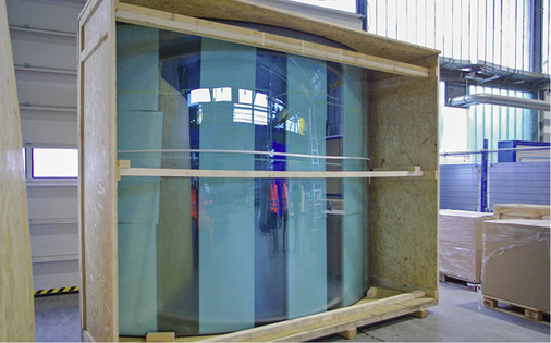 
Solche Holzverpackungen schützen die gebogenen Großformat-Scheiben während der Auslieferung, im Fall der Eck-Elemente für die Fassade am „Atrium Komplex“ in Amsterdam.



