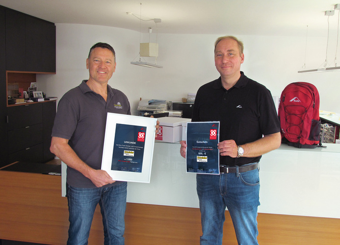 Außendienstmitarbeiter Thomas Wenger bedankte sich u. a. mit einer Urkunde bei Geschäftsführer Bernhard Schnitzler (l.) dafür, dass Glaserei und Fensterbau Schnitzler 1.000 Mitstreiter der “Quadro Safe“-Kampagne ist. - Roto