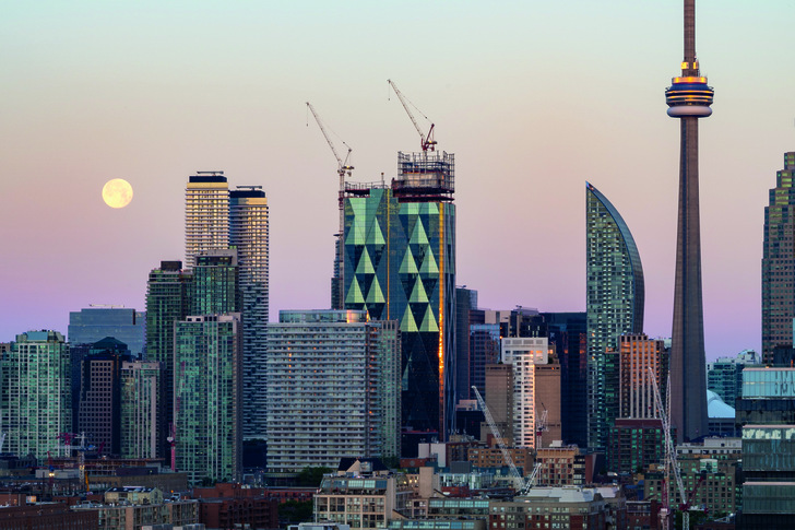 Atemberaubende Ansicht: Die Skyline des Stadtzentrums von Toronto  am frühen Morgen und bei Vollmond.