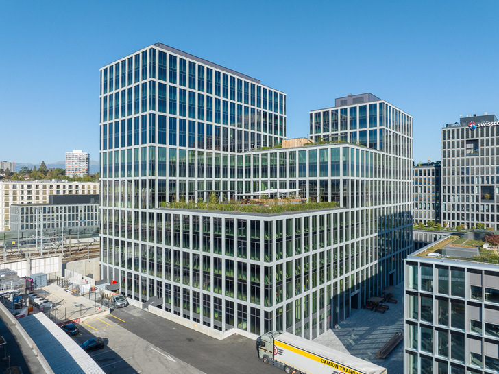 Das Bürogebäude Alto ist Teil des Projekts Esplanade de Pont-Rouge, eines neuen Geschäftsviertels in Genf. Die Fassade ist mit schaltbaren Sonnenschutzgläser ausgestattet. - © Adrien Barakat
