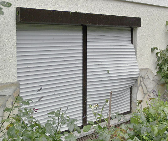 
Ein typisches Schadensbild nach einem leichten Orkanwind. Der Rollladenpanzer wird durch den Windsog aus der Führungsschiene gezogen.
