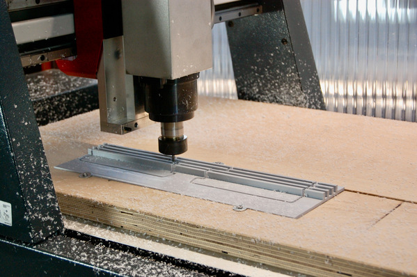 Der Fräskopf frisst sich millimetergenau durch den Kunststoff des Blendrahmenadapters – genau diesen Arbeitsschritt nimmt Alumat auf Grundlage der gelieferten CAD Zeichnung Holzfensterbauern künftig ab.