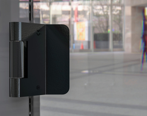 Elegant und dezent unterstützen die Bandlösungen von Breuer und Schmitz – hier das 3D-System VZX für stumpf anschlagende Türen in Mattschwarz – die Wirkung von Glastüren.