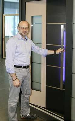 



Alessandro Sbarretti vor einer Tür, die u. a. mit Fuhr-Beschlägen ausgestattet ist.
